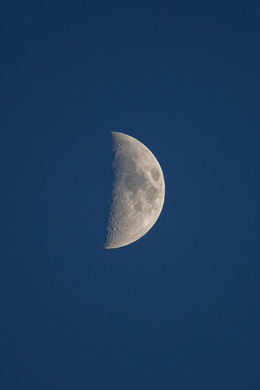 crescent moon against deep blue sky
